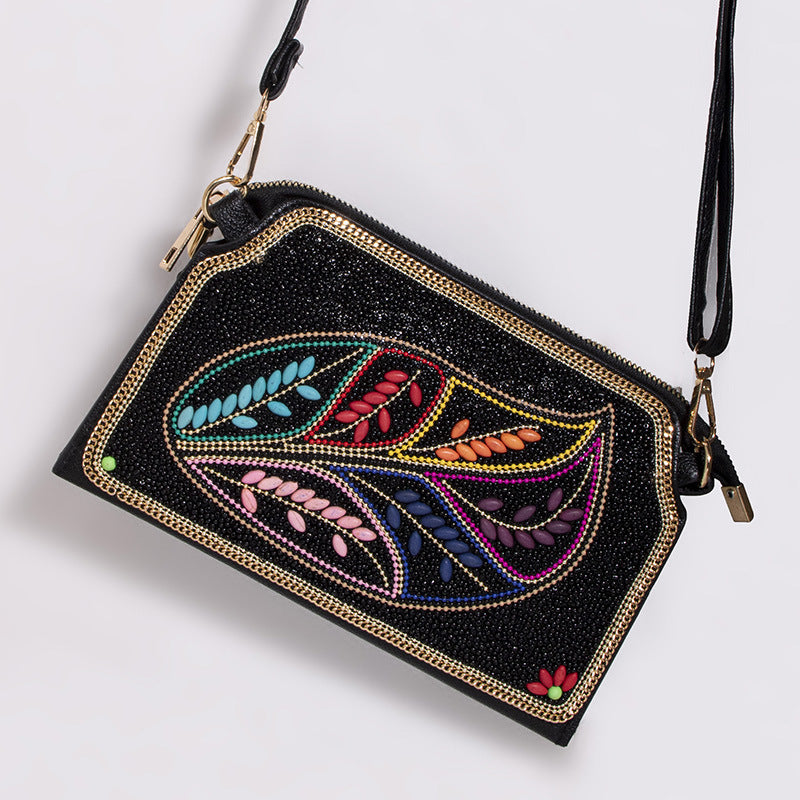 Embroidered crossbody bag with embellishments