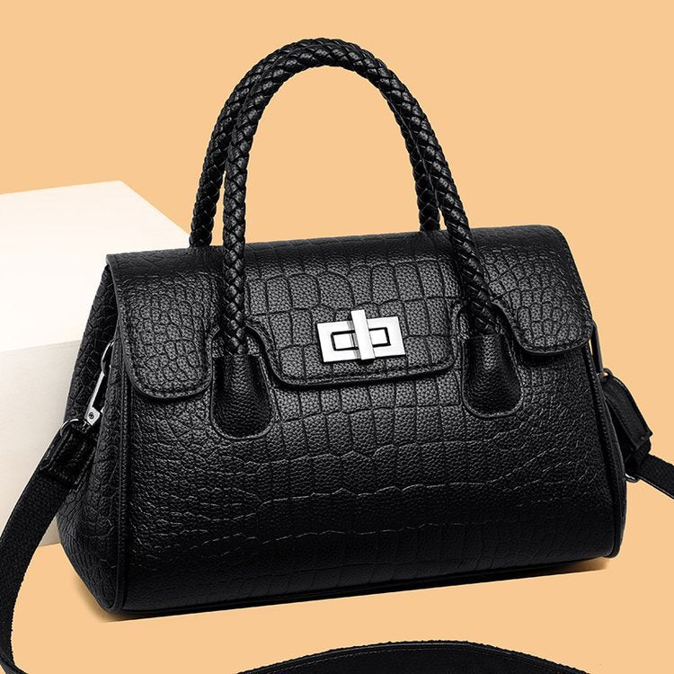 Embossed handbag with turn-lock closure