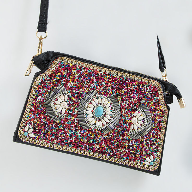 Embroidered crossbody bag with embellishments