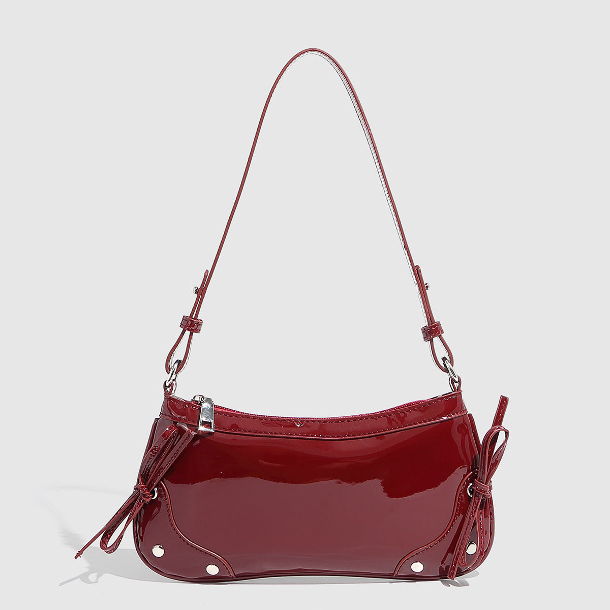 Glossy shoulder bag with side ties