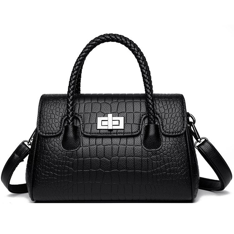 Embossed handbag with turn-lock closure