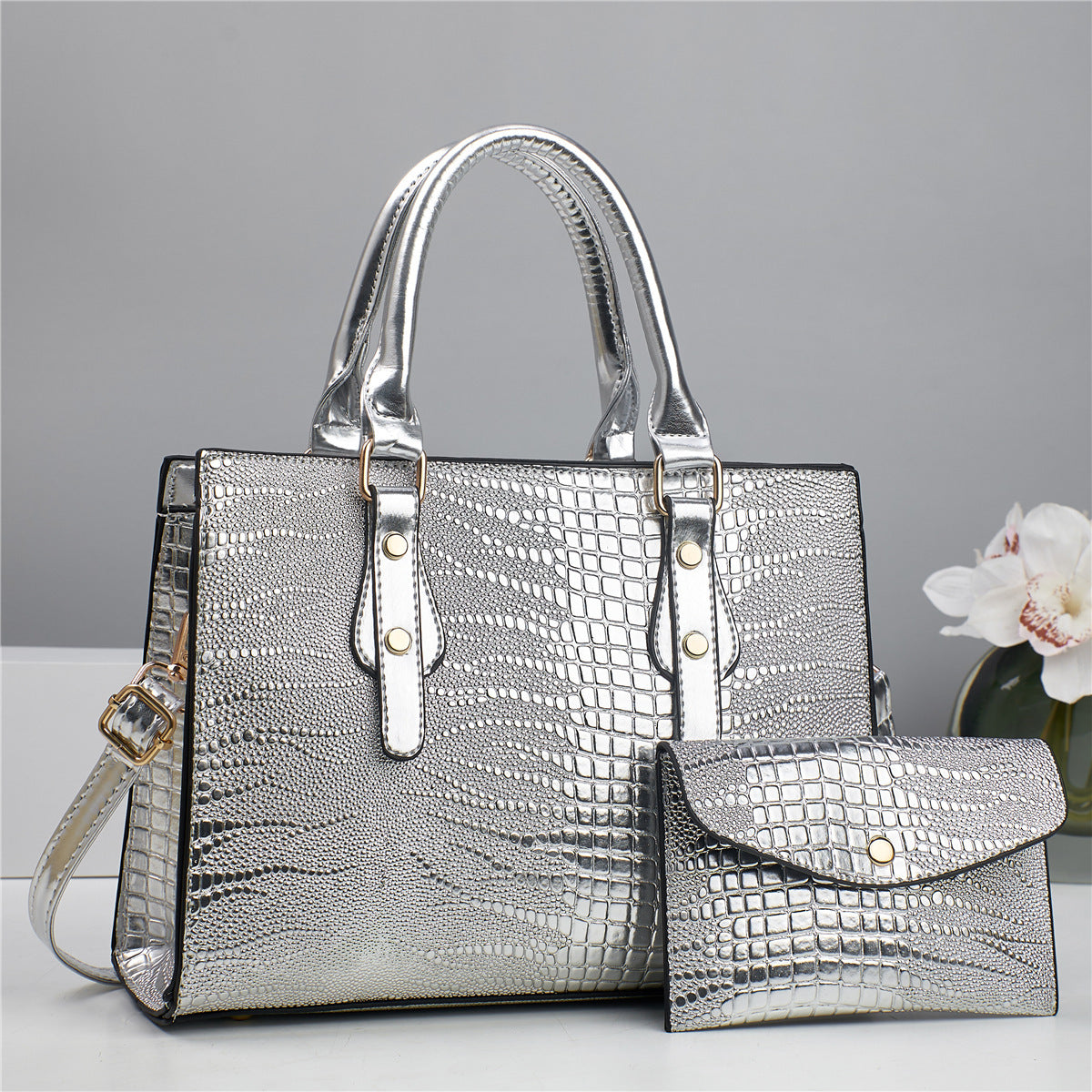 Embossed handbag with matching pouch