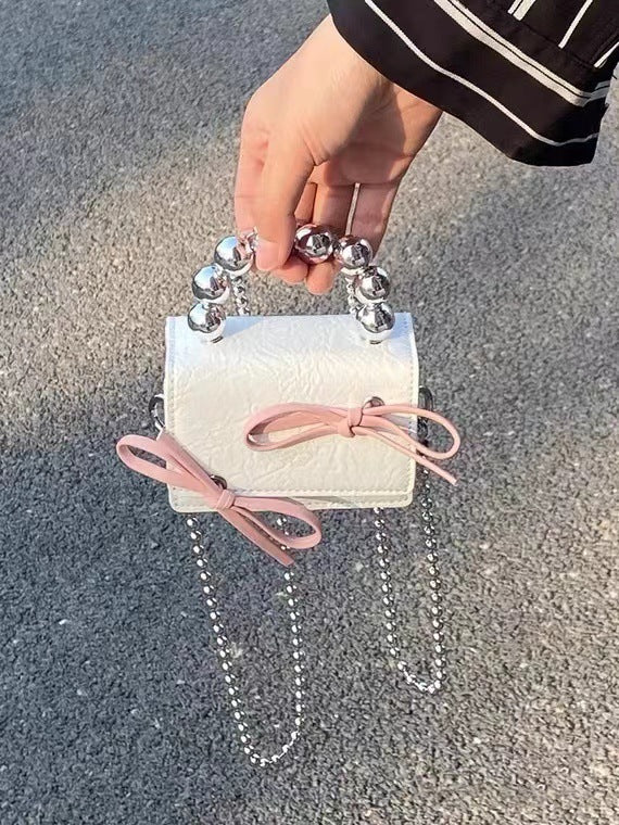 Mini handbag with bow and beaded handle