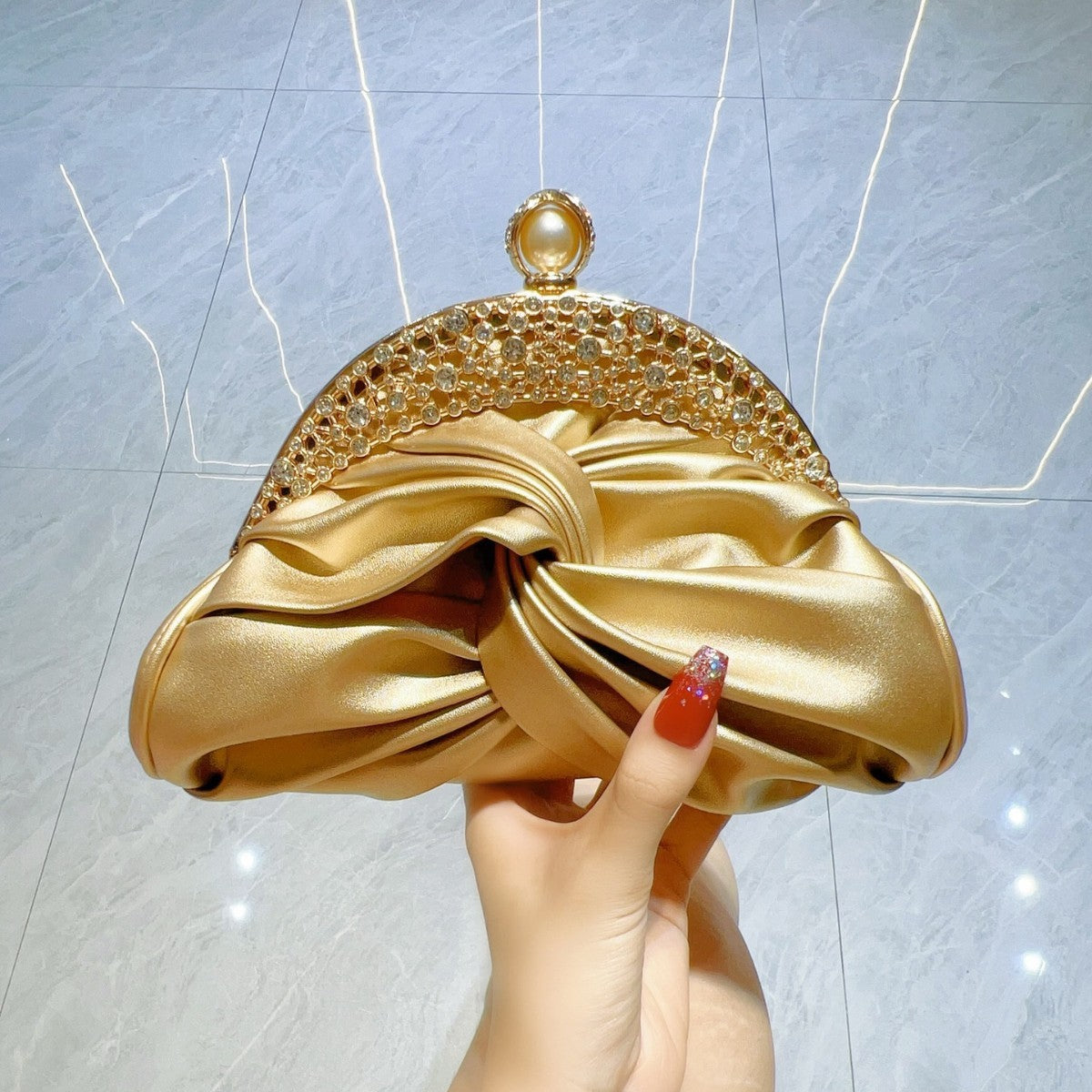 Satin clutch bag with metal frame