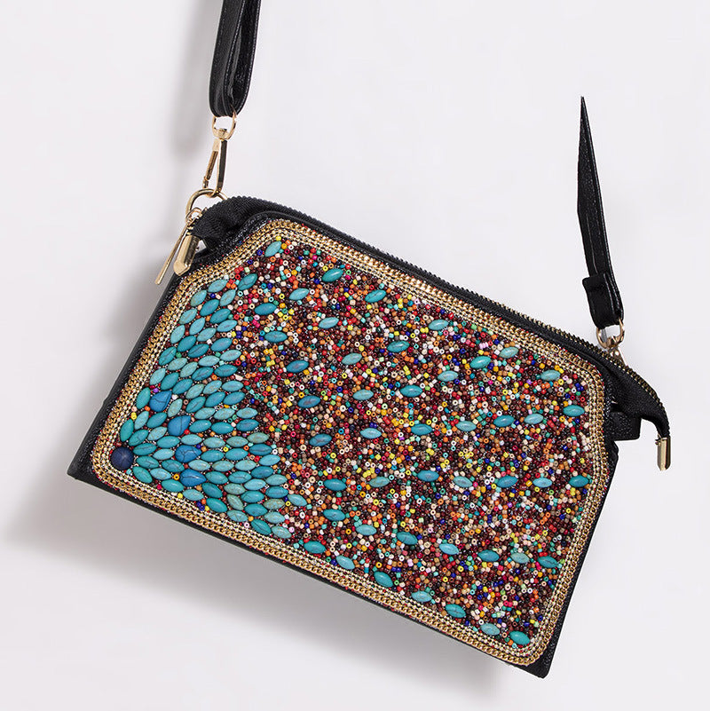 Embroidered crossbody bag with embellishments
