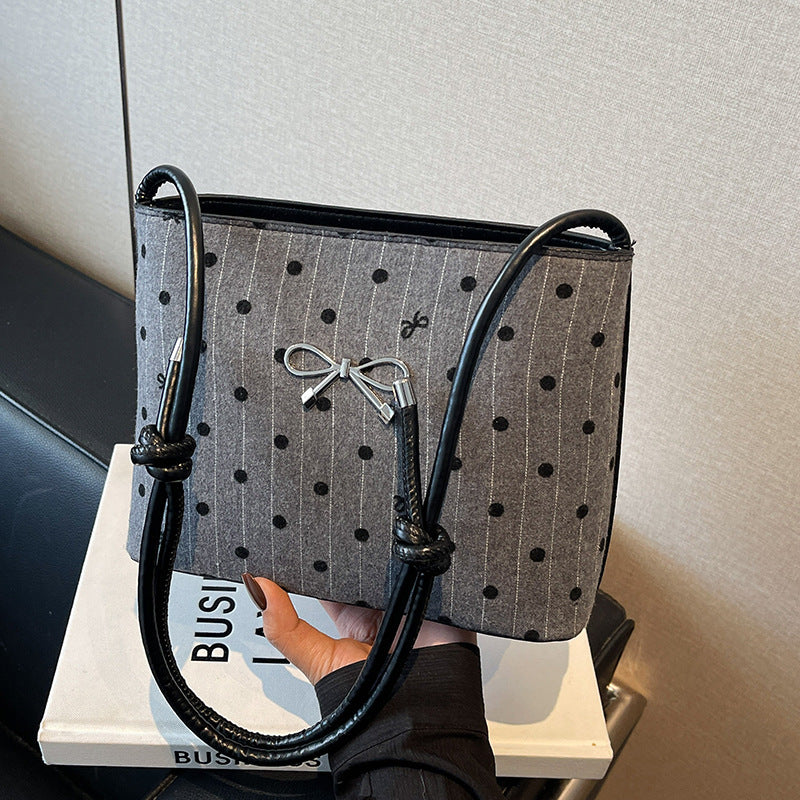 Structured handbag with perforated surface