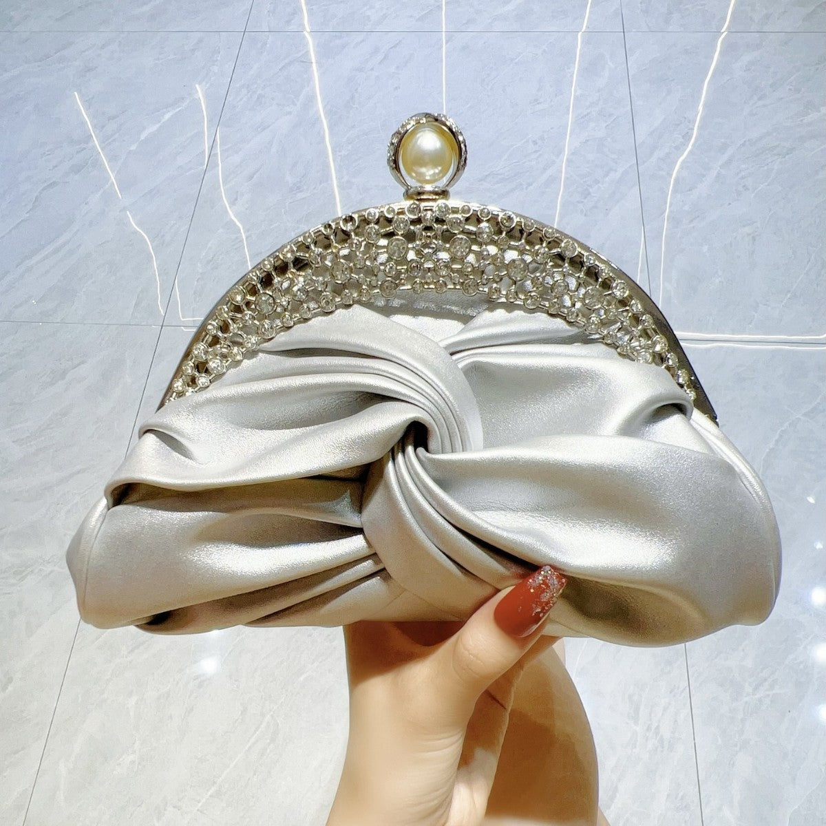 Satin clutch bag with metal frame