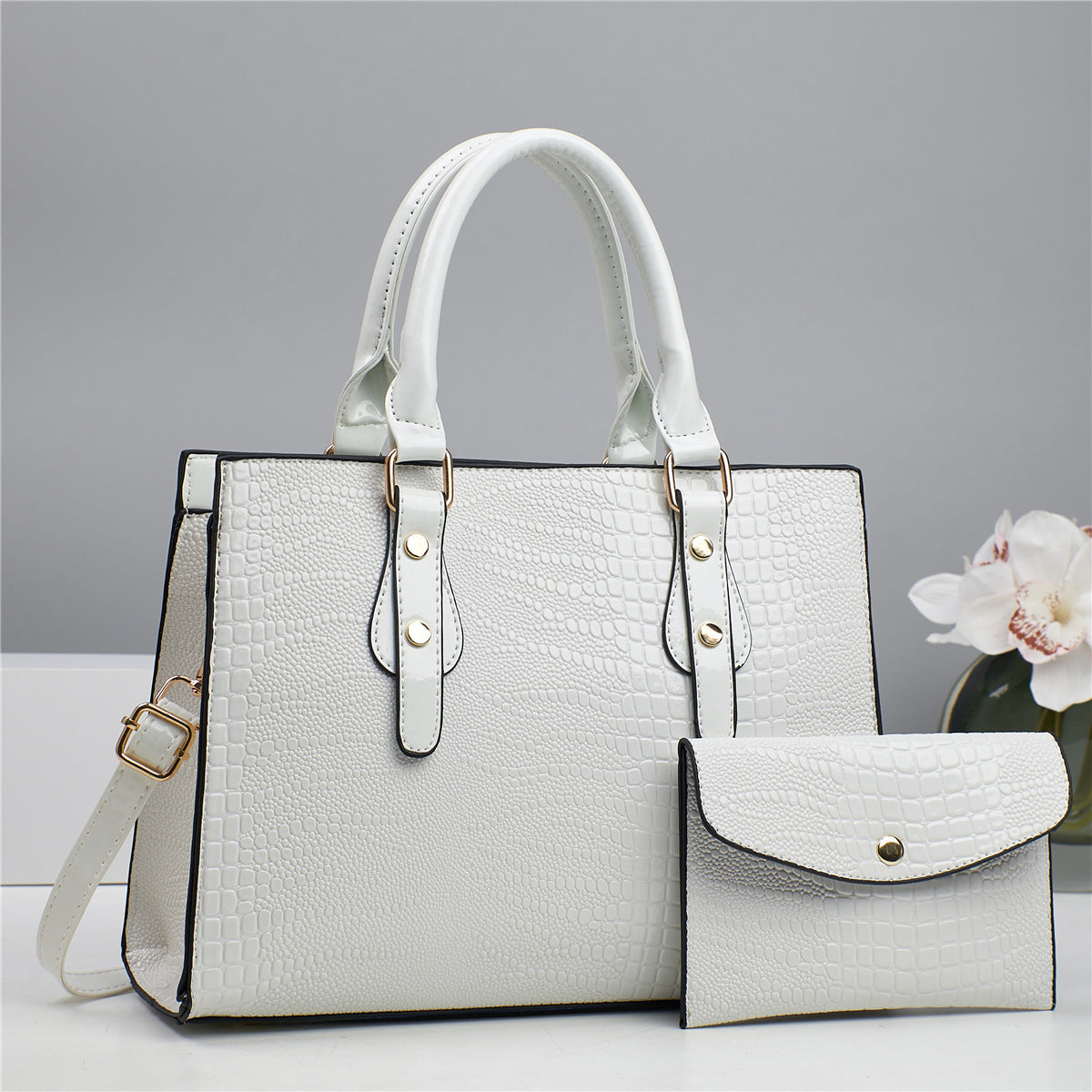 Embossed handbag with matching pouch