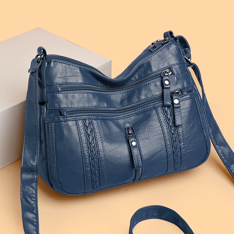 Multi-pocket shoulder bag with zipper closure