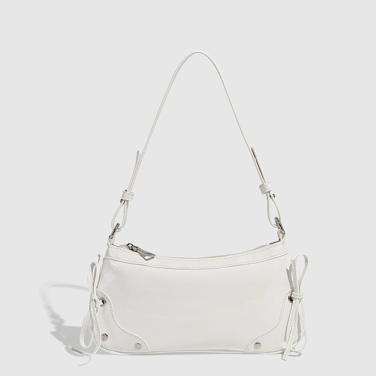 Glossy shoulder bag with side ties