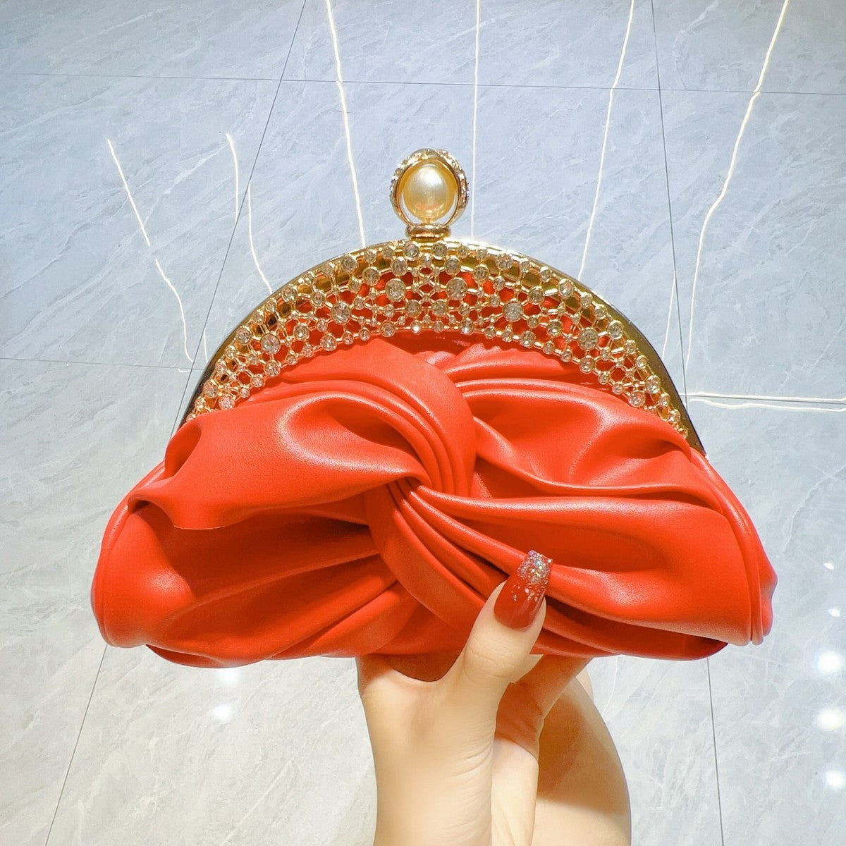 Satin clutch bag with metal frame