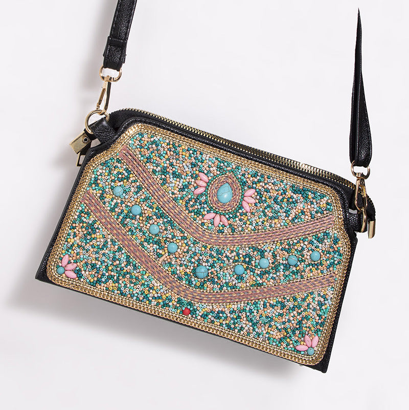 Embroidered crossbody bag with embellishments