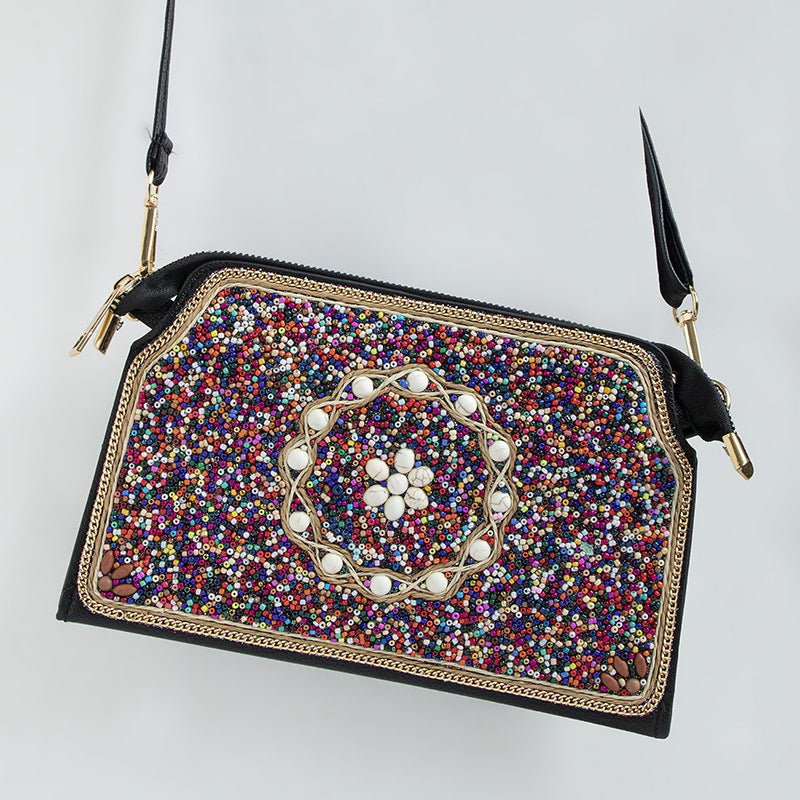 Embroidered crossbody bag with embellishments
