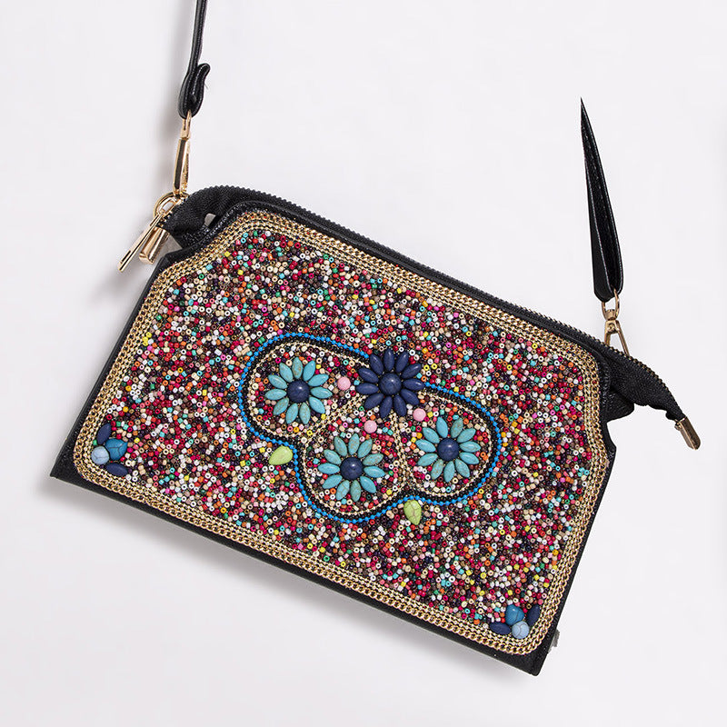 Embroidered crossbody bag with embellishments
