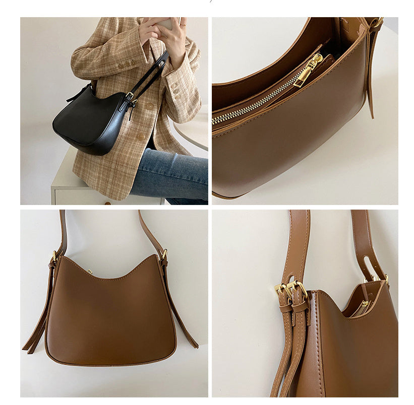 Curved shoulder bag with zipper closure