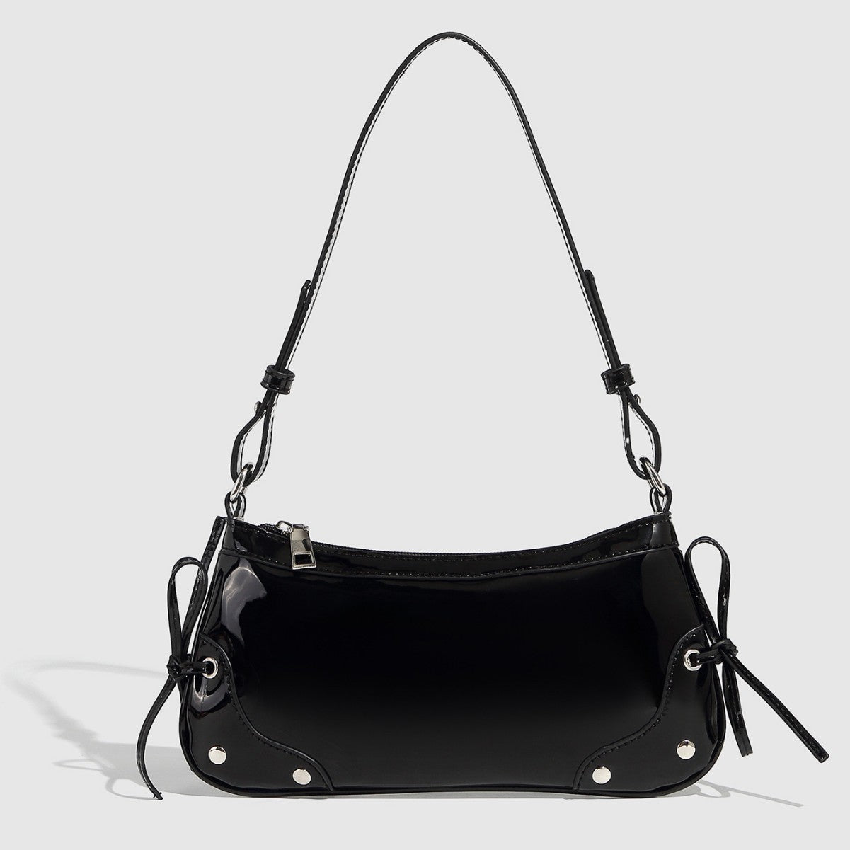 Glossy shoulder bag with side ties