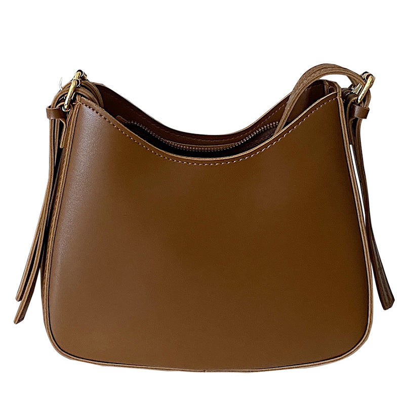 Curved shoulder bag with zipper closure