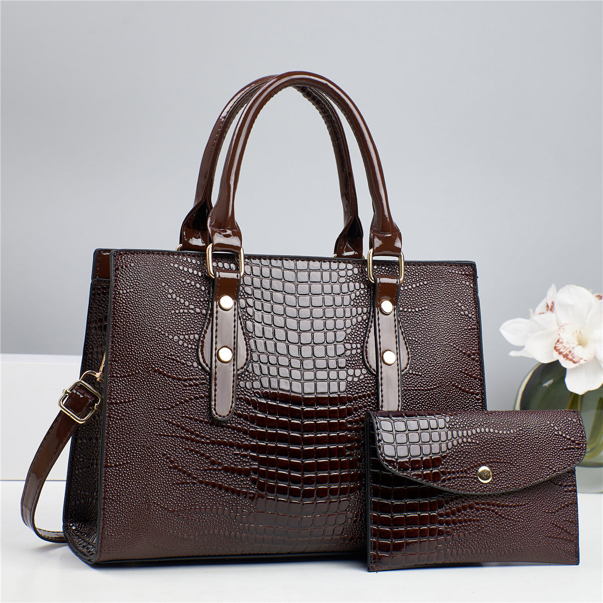 Embossed handbag with matching pouch