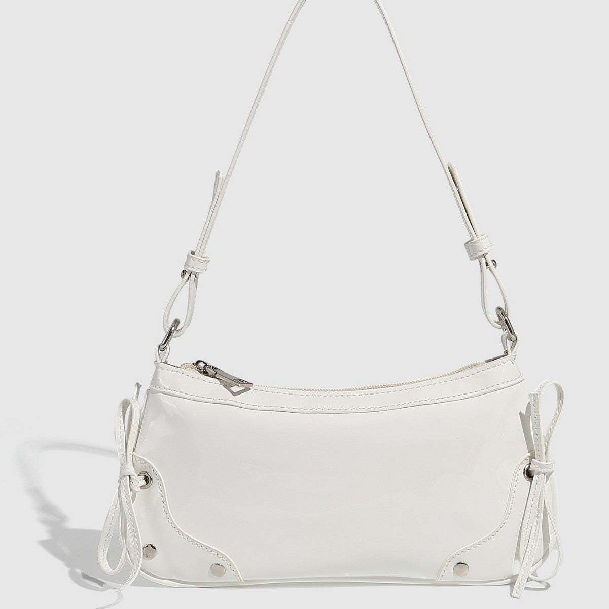 Glossy shoulder bag with side ties