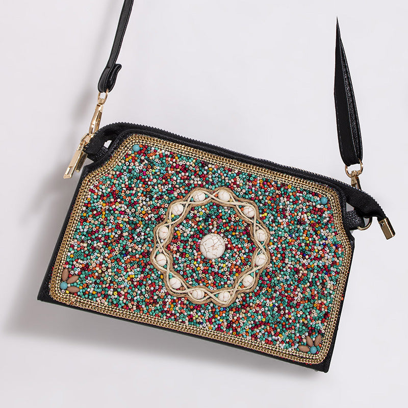 Embroidered crossbody bag with embellishments
