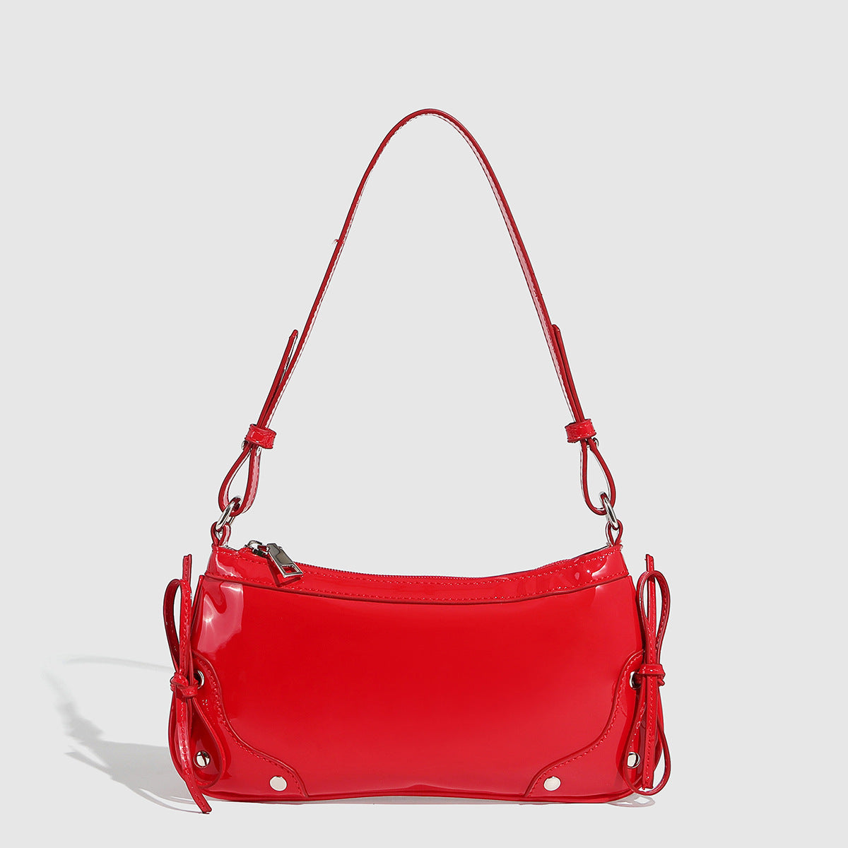 Glossy shoulder bag with side ties