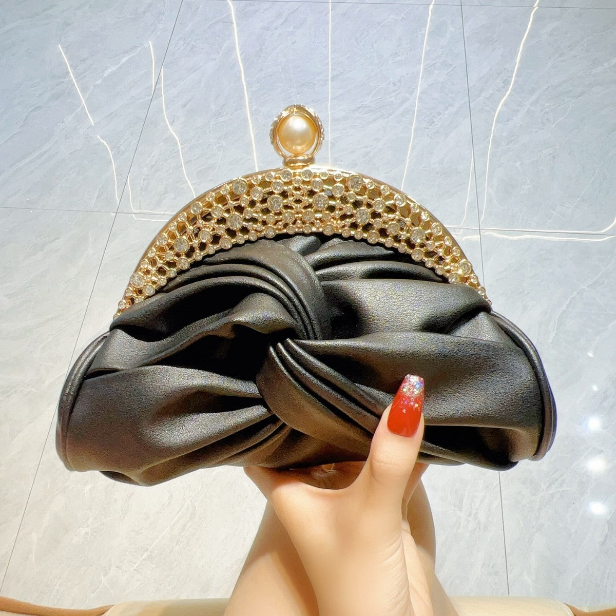 Satin clutch bag with metal frame