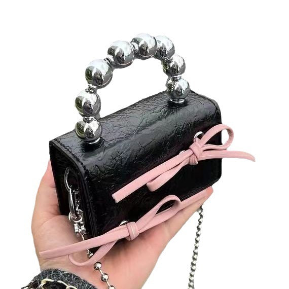 Mini handbag with bow and beaded handle