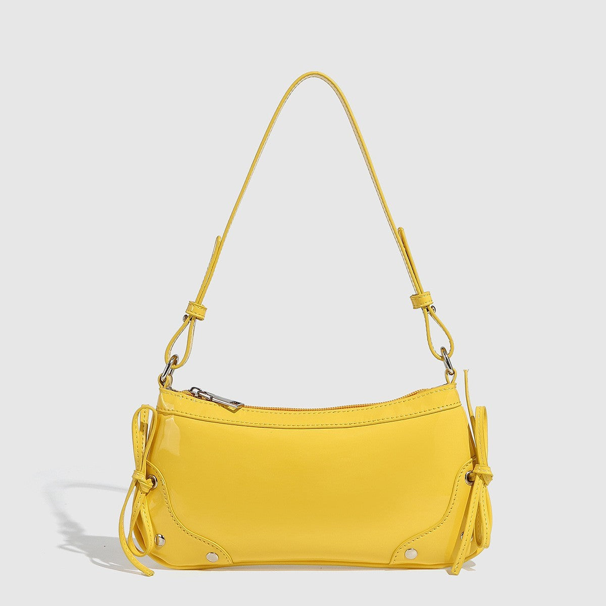 Glossy shoulder bag with side ties