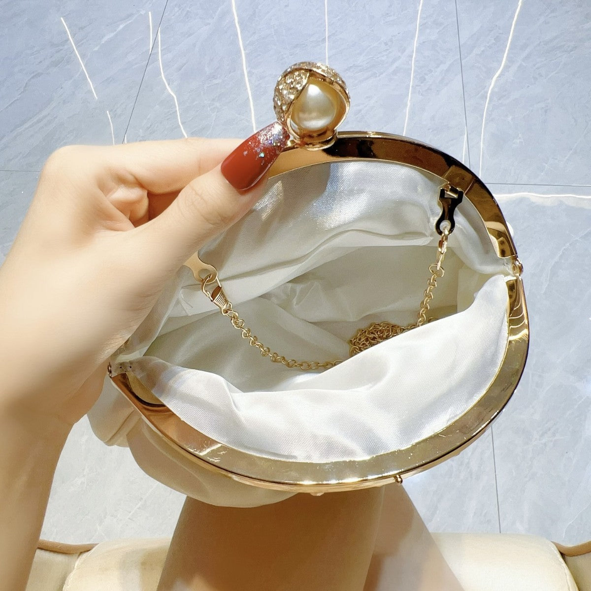 Satin clutch bag with metal frame
