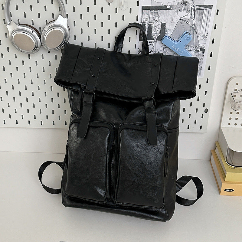 Fold-over flap backpack with front pocket