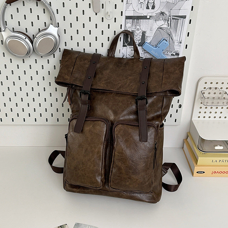 Fold-over flap backpack with front pocket