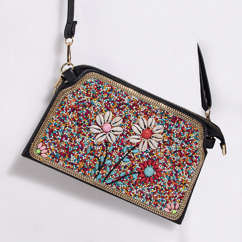 Embroidered crossbody bag with embellishments