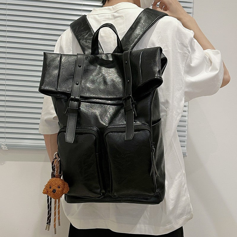 Fold-over flap backpack with front pocket