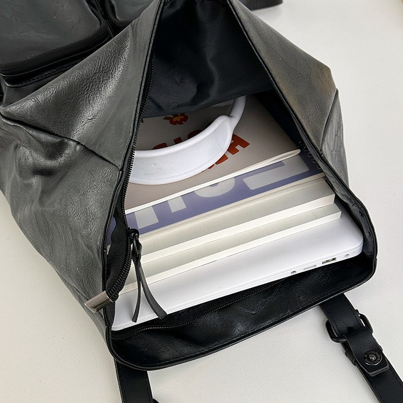 Fold-over flap backpack with front pocket