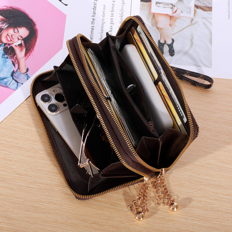 Patterned zip-around wallet with wrist strap