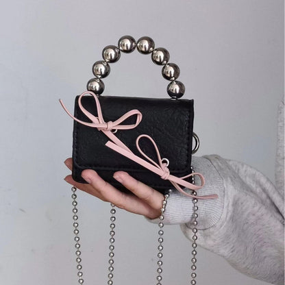Mini handbag with bow and beaded handle