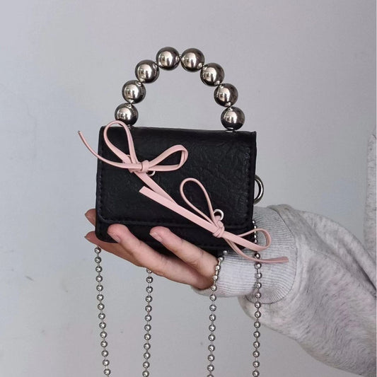 Mini handbag with bow and beaded handle