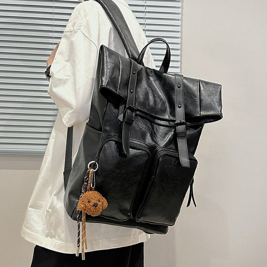 Fold-over flap backpack with front pocket