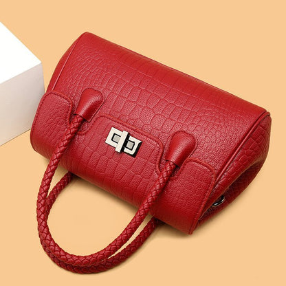 Embossed handbag with turn-lock closure