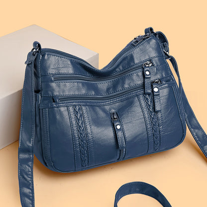 Multi-pocket shoulder bag with zipper closure