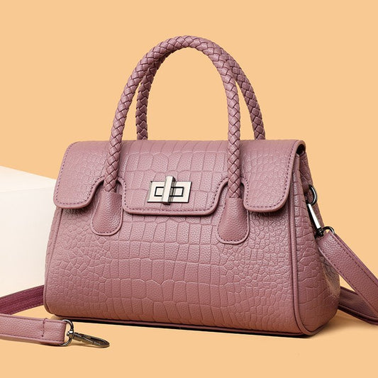 Embossed handbag with turn-lock closure