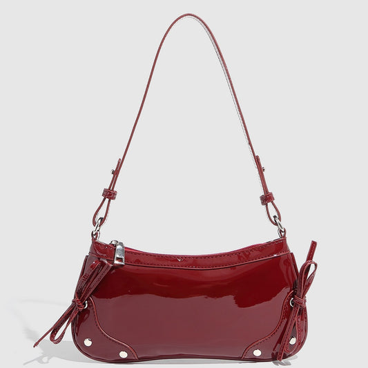 Glossy shoulder bag with side ties