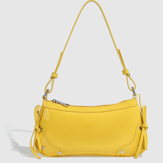 Glossy shoulder bag with side ties
