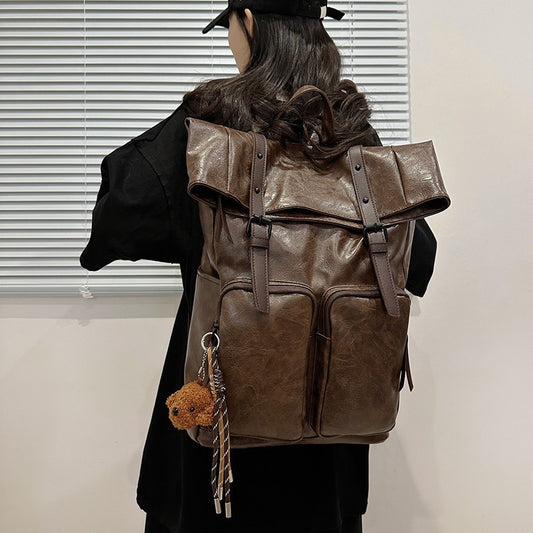 Fold-over flap backpack with front pocket