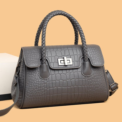 Embossed handbag with turn-lock closure