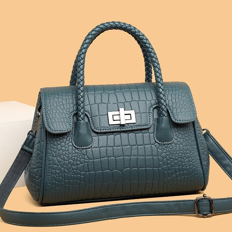 Embossed handbag with turn-lock closure
