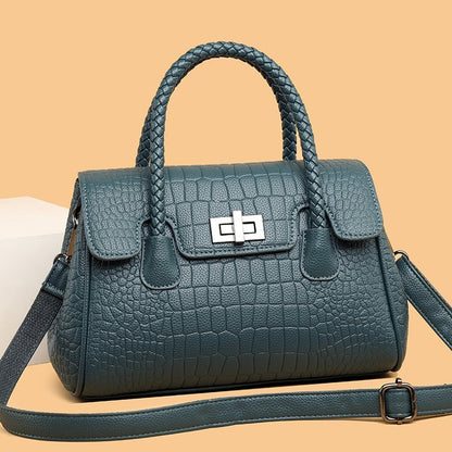 Embossed handbag with turn-lock closure