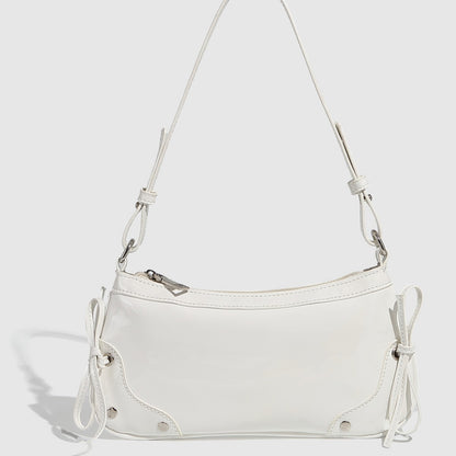 Glossy shoulder bag with side ties