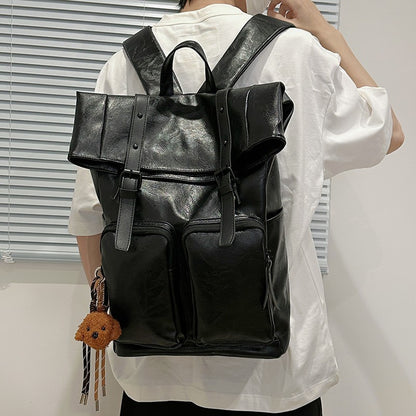 Fold-over flap backpack with front pocket